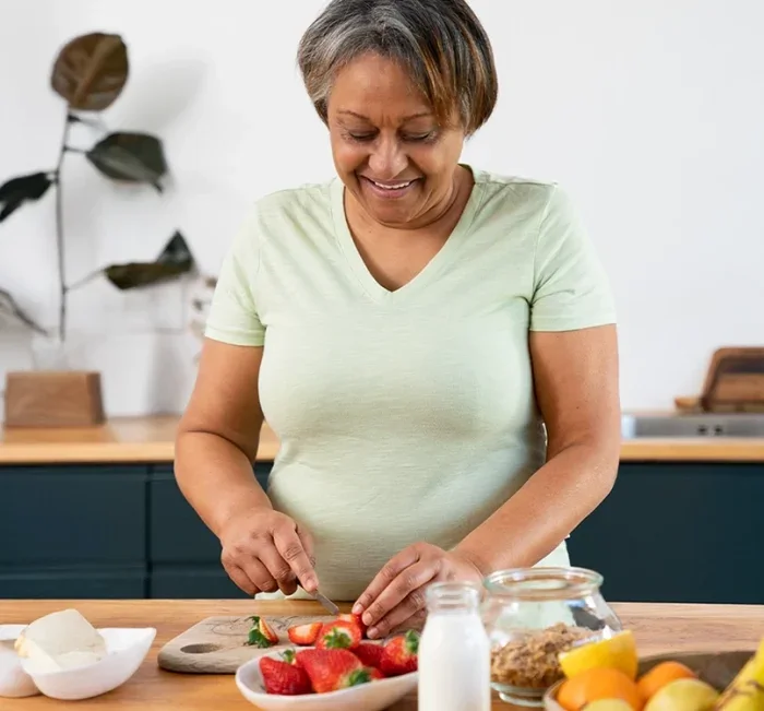 Woman preparing a balanced meal at home alongside her GlucoBliss routine