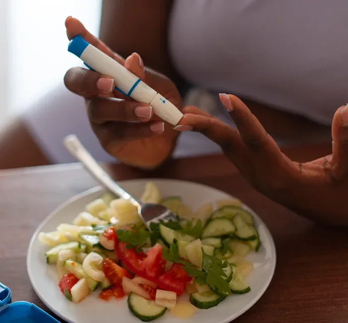 Checking blood sugar at the table as part of a daily GlucoBliss routine